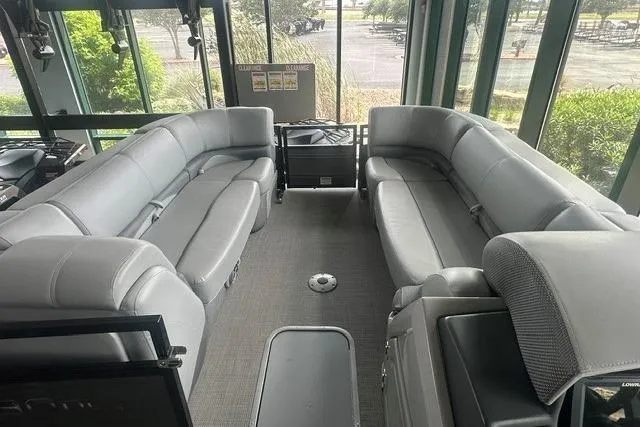 Slide: The Image of Luxurious interior of 2025 Regency 230 DL3 pontoon boat with plush seating. - 4