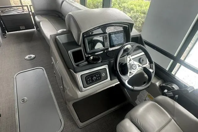 Slide: The Image of 2025 Regency 230 DL3 boat interior with modern steering console and seating. - 5