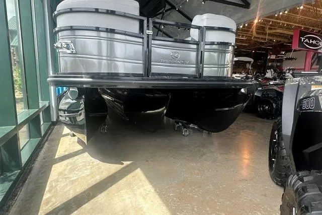 Slide: The Image of 2025 Regency 230 DL3 pontoon boat displayed indoors with sleek design. - 2