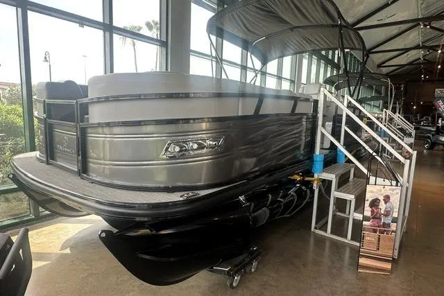 The Image of 2025 Regency 230 DL3 pontoon boat displayed indoors with sleek design and modern features. - 0