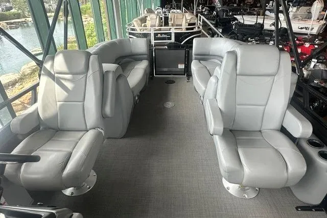 Slide: The Image of Luxurious interior of 2025 Regency 230 DL3 pontoon boat with plush seating. - 6