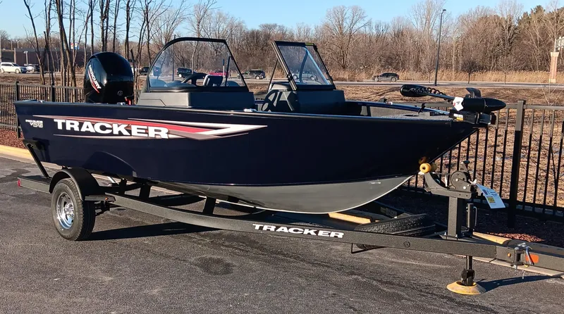 Slide: The Image of 2025 Tracker Pro Guide V-175 WT boat on trailer, parked outdoors. - 2