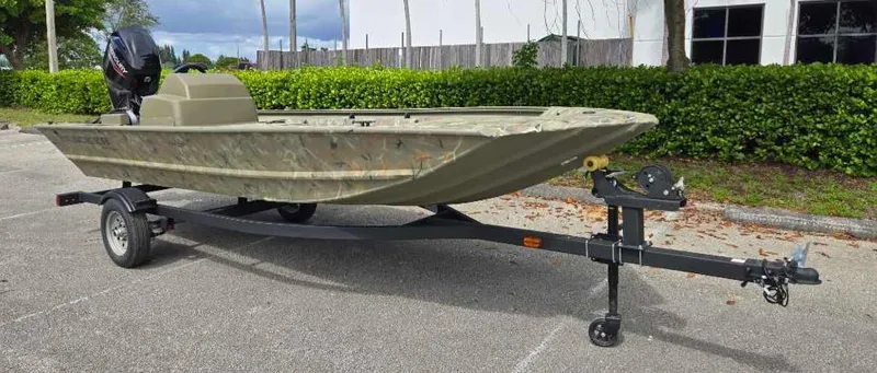 Slide: The Image of 2025 Tracker Grizzly 1648 SC boat on trailer in parking lot. - 3