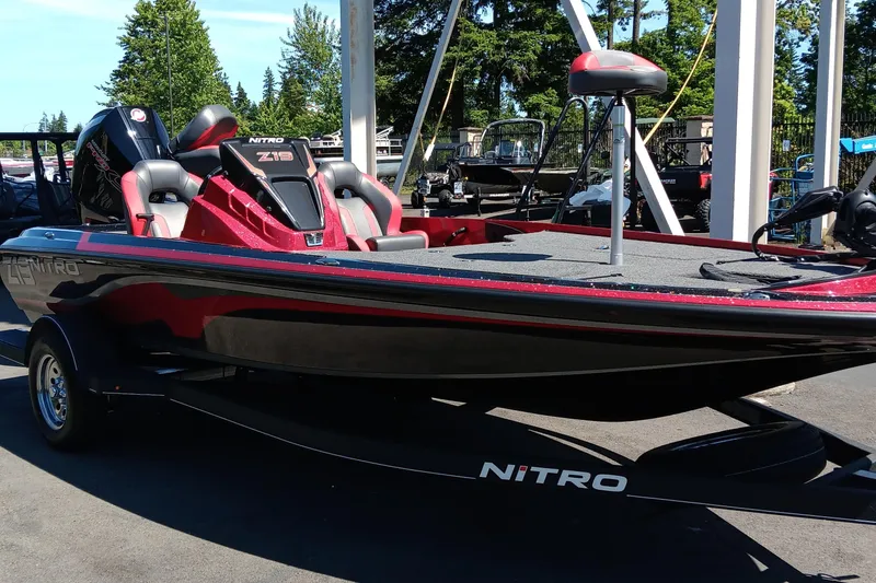 Slide: The Image of 2025 Nitro Z19 boat in red and black, parked outdoors on a trailer. - 1