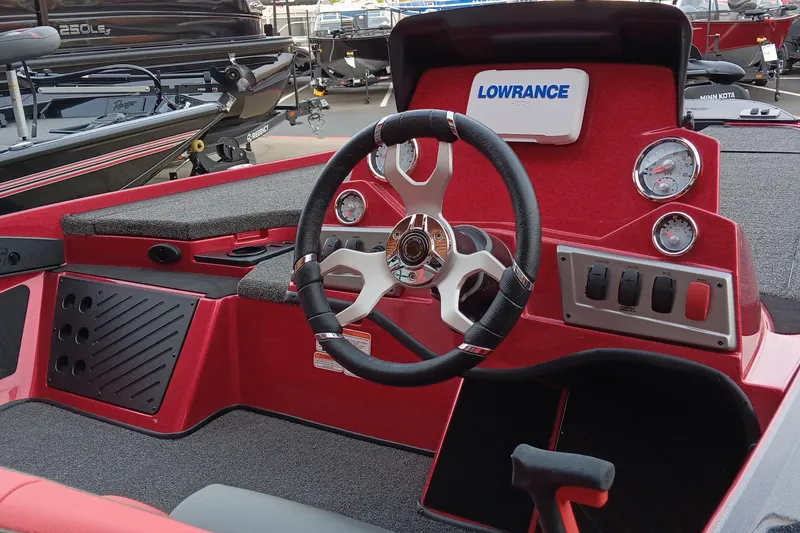 Slide: The Image of 2025 Nitro Z19 boat dashboard with steering wheel and Lowrance electronics. - 2