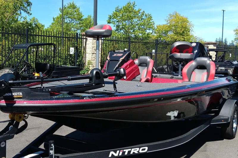 Slide: The Image of 2025 Nitro Z19 boat with red and black design, parked outdoors. - 4