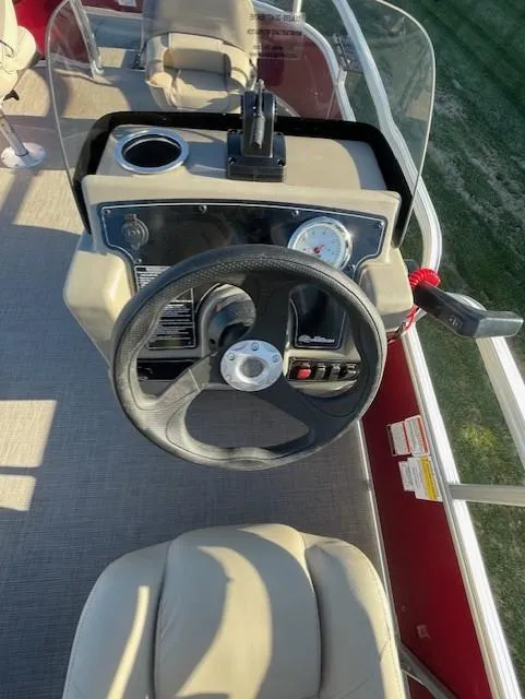 Slide: The Image of 2025 Sun Tracker Bass Buggy 16 XL Select steering console with gauges and controls. - 4