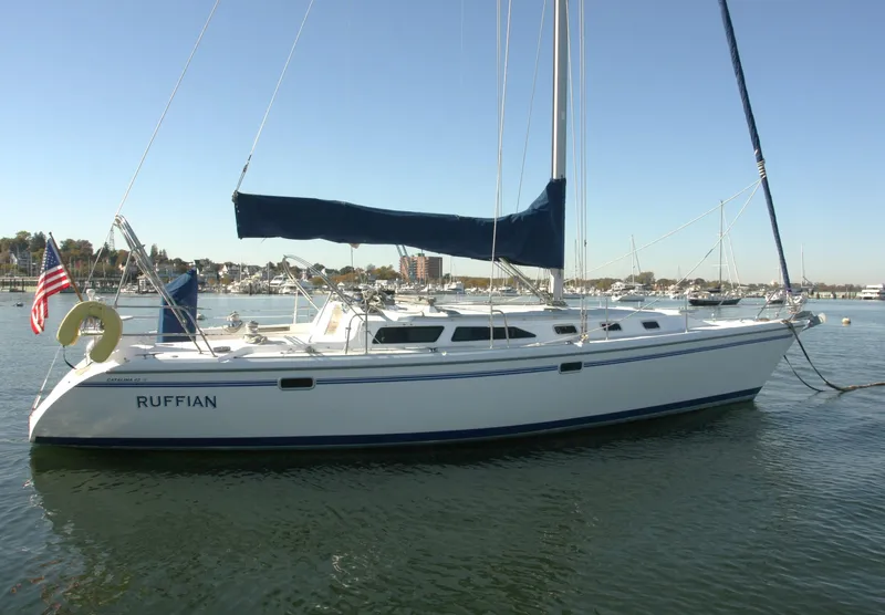 The Image of 1998 Catalina 42 Mk II sailboat on calm water, clear sky background. - 0