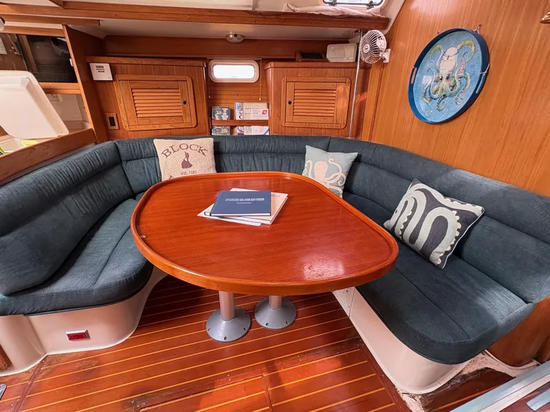 Slide: The Image of Interior of 1998 Catalina 42 Mk II sailboat with wood paneling and cozy seating area. - 13
