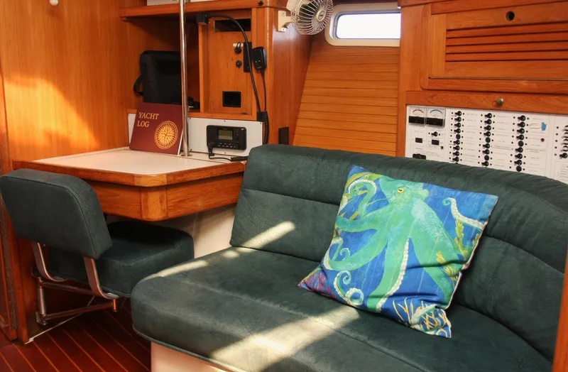 Slide: The Image of Interior of 1998 Catalina 42 Mk II sailboat with blue seating and navigation equipment. - 15