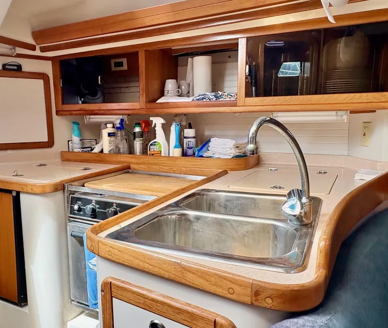Slide: The Image of Interior of 1998 Catalina 42 Mk II sailboat kitchen with sink and stove. - 19