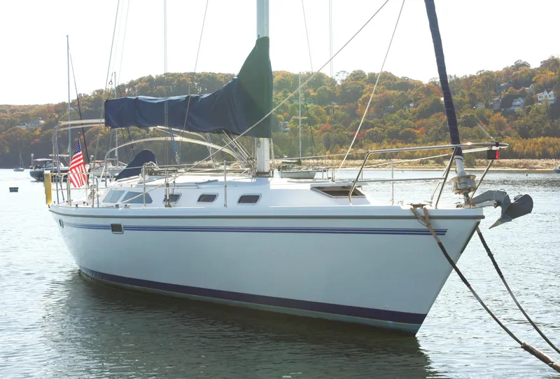 Slide: The Image of 1998 Catalina 42 Mk II sailboat on stands in a marina, named "Ruffian." - 2