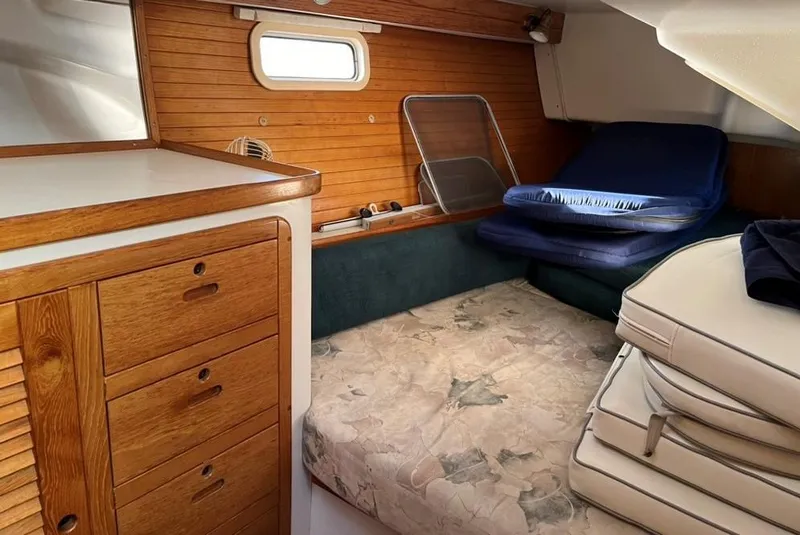 Slide: The Image of 1998 Catalina 42 Mk II yacht kitchen with sink, stove, and wooden cabinetry. - 20