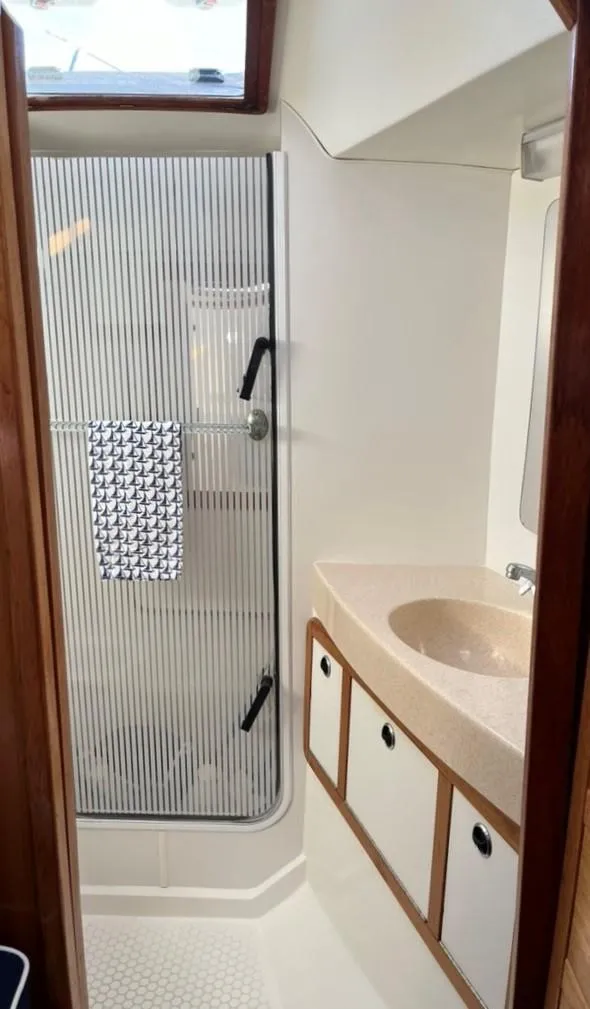 Slide: The Image of Bathroom interior of a 1998 Catalina 42 Mk II yacht with toilet and mirror. - 23