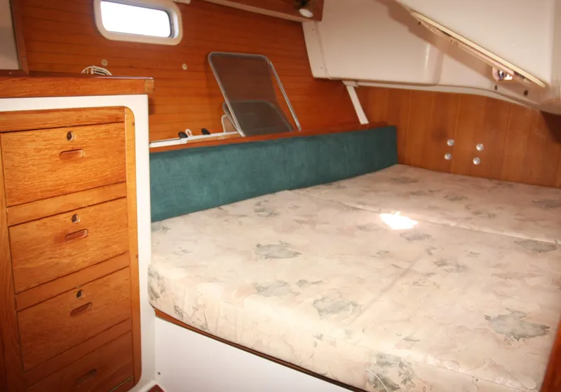 Slide: The Image of Cozy cabin bed with nautical-themed pillows in a 1998 Catalina 42 Mk II sailboat. - 27