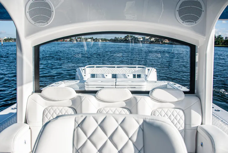 Slide: The Image of Luxurious interior of 2022 HCB 53 Sueños boat with white seating on water. - 16