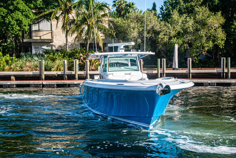 Slide: The Image of 2022 HCB 53 Sueños boat cruising in a tropical waterfront setting. - 21