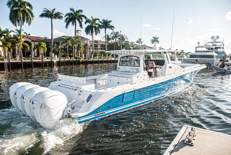 Slide: The Image of 2022 HCB 53 Sueños boat cruising near a tropical waterfront. - 25