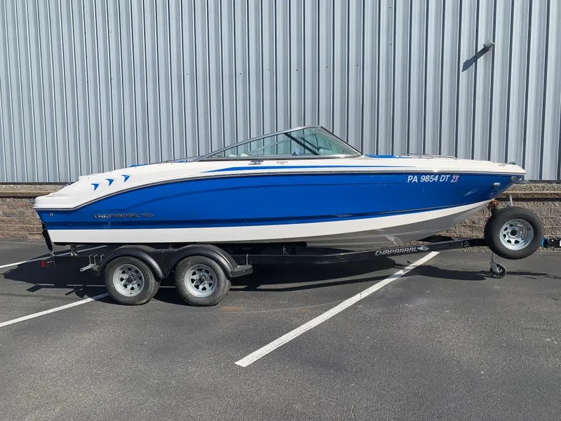 Slide: The Image of 2018 Chaparral 21 H2O Sport boat on trailer, blue and white exterior. - 1