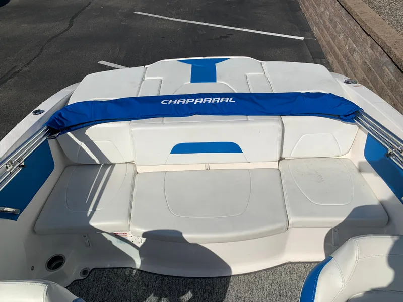 Slide: The Image of 2018 Chaparral 21 H2O Sport boat interior with white and blue seating. - 10