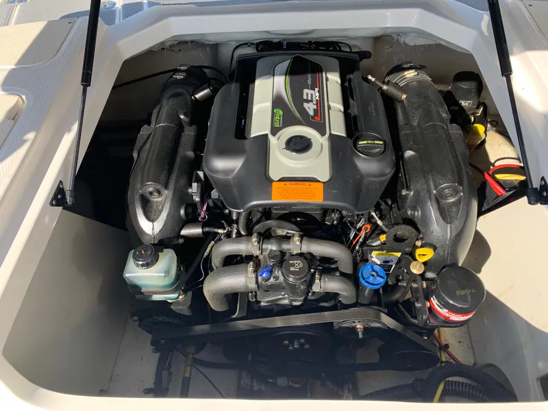 Slide: The Image of 2018 Chaparral 21 H2O Sport engine compartment, showcasing powerful inboard motor. - 11