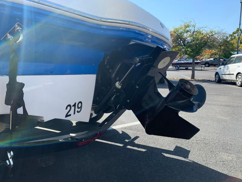 Slide: The Image of 2018 Chaparral 21 H2O Sport boat stern and propeller in parking lot. - 13