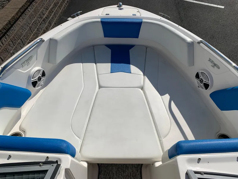 Slide: The Image of 2018 Chaparral 21 H2O Sport boat interior with blue and white seating. - 3