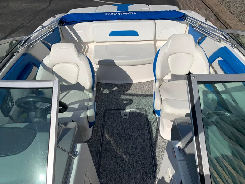 Slide: The Image of 2018 Chaparral 21 H2O Sport boat interior with white and blue seating. - 4