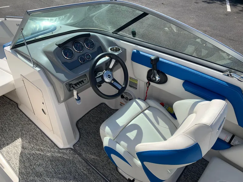 Slide: The Image of 2018 Chaparral 21 H2O Sport boat interior with steering wheel and dashboard. - 5