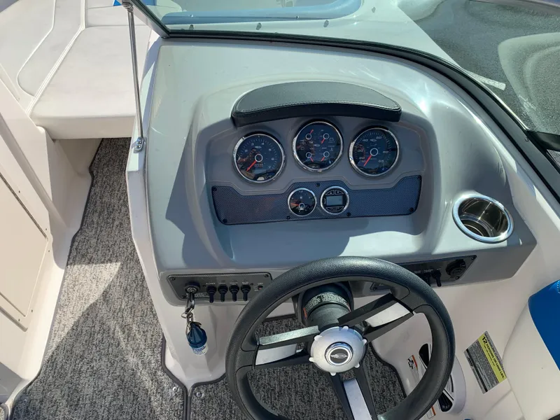 Slide: The Image of 2018 Chaparral 21 H2O Sport boat dashboard with steering wheel and gauges. - 6