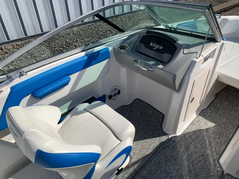 Slide: The Image of 2018 Chaparral 21 H2O Sport boat interior with blue and white seating. - 8
