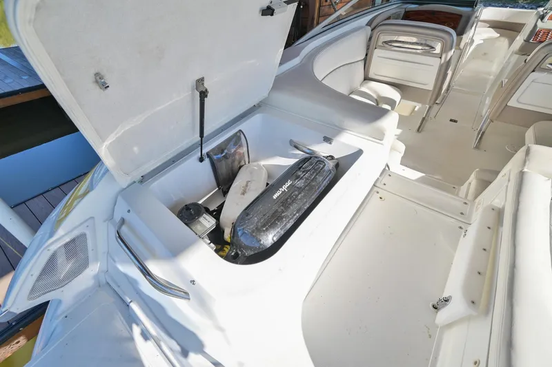 Slide: The Image of Open storage compartment in a 2002 Cobalt 262 boat, showing interior space and equipment. - 10