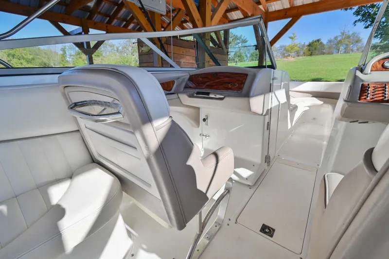 Slide: The Image of Interior of 2002 Cobalt 262 boat with white seating and wooden accents. - 20