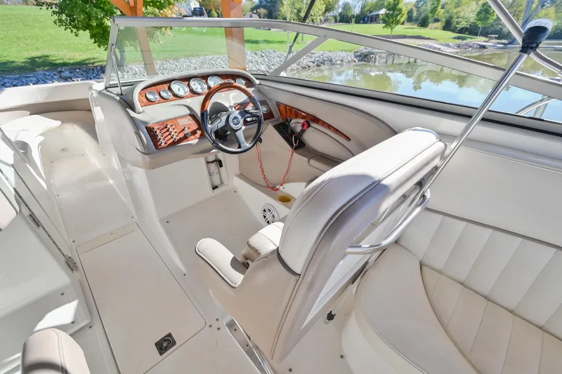 Slide: The Image of Interior of a 2002 Cobalt 262 boat with steering wheel and dashboard. - 24