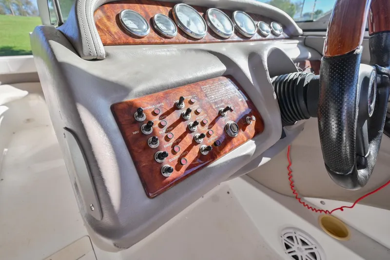 Slide: The Image of 2002 Cobalt 262 boat dashboard with control panel and steering wheel. - 27