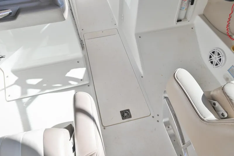 Slide: The Image of Interior of a 2002 Cobalt 262 boat, featuring white seating and flooring. - 31