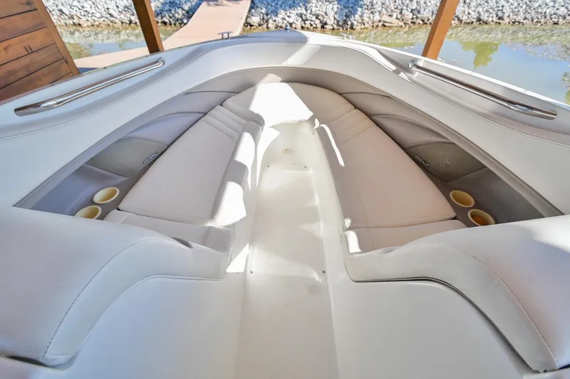 Slide: The Image of Interior of 2002 Cobalt 262 boat with white seating and cup holders. - 32