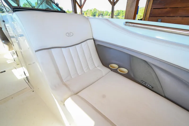 Slide: The Image of Luxurious seating on a 2002 Cobalt 262 boat, featuring white upholstery and cup holders. - 34