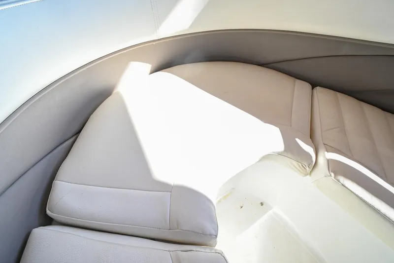 Slide: The Image of Interior seating of a 2002 Cobalt 262 boat, featuring beige cushions and sleek design. - 38