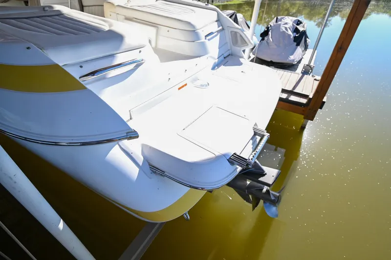 Slide: The Image of 2002 Cobalt 262 boat docked, rear view with swim platform and outboard motor. - 6