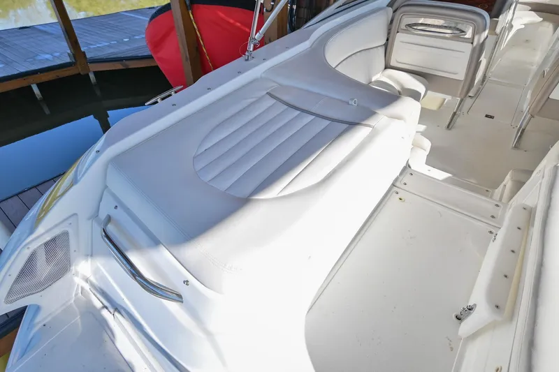 Slide: The Image of 2002 Cobalt 262 boat interior with white seating and deck area. - 9