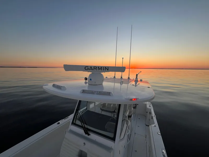 Slide: The Image of Edgewater 340CC boat at sunset on calm waters, 2022 model. - 11