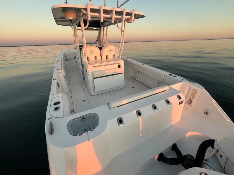 Slide: The Image of 2022 Edgewater 340CC boat on calm water at sunset. - 12