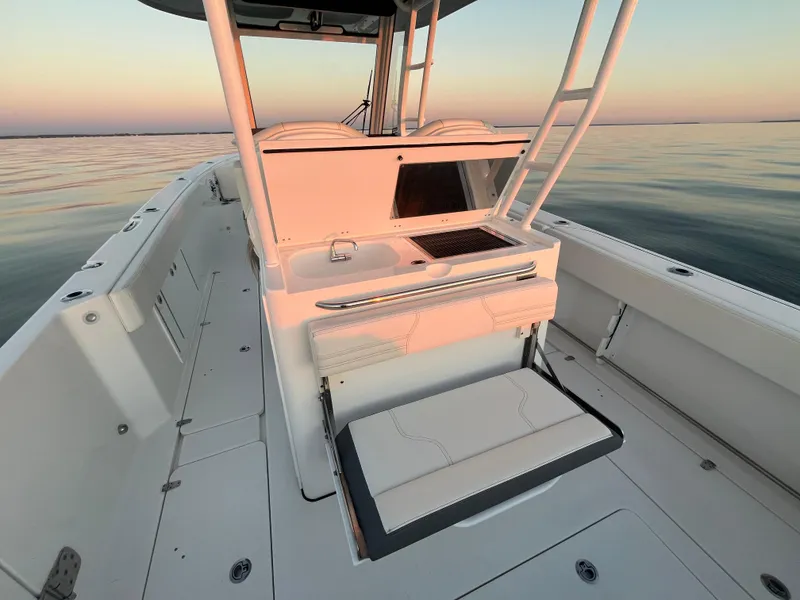 Slide: The Image of Edgewater 340CC 2022 boat interior at sunset on calm water. - 14