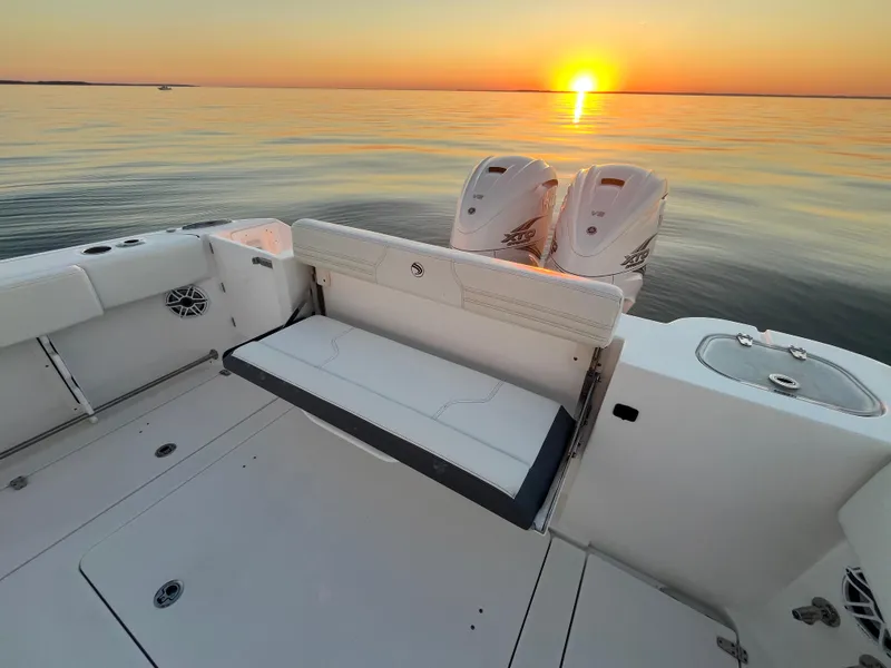 Slide: The Image of Edgewater 340CC 2022 boat interior at sunset on calm water. - 15