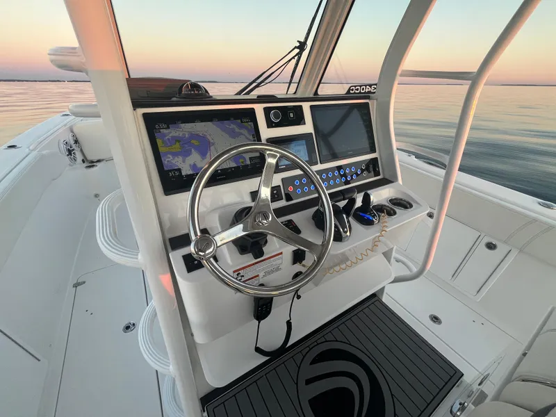 Slide: The Image of Edgewater 340CC 2022 boat helm with modern navigation system at sunset. - 16