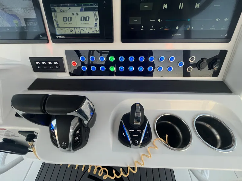 Slide: The Image of Edgewater 340CC 2022 boat dashboard with controls and digital displays. - 19