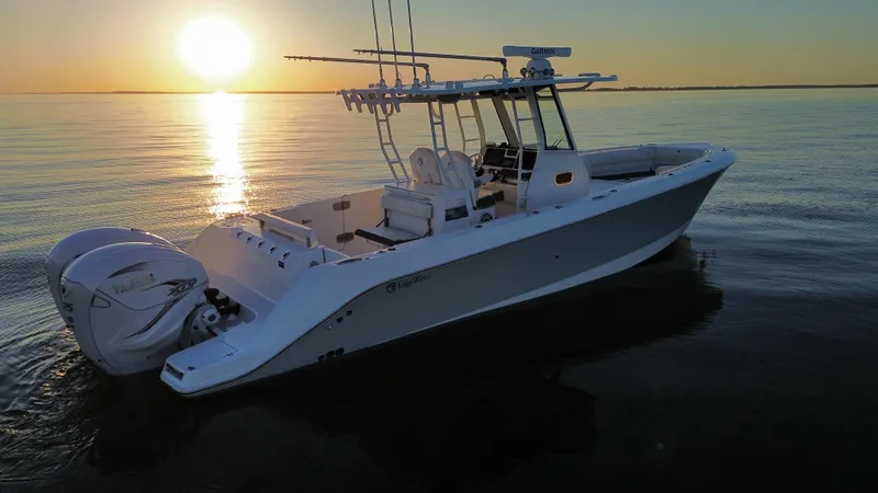 Slide: The Image of Edgewater 340CC 2022 boat at sunset on calm waters. - 2