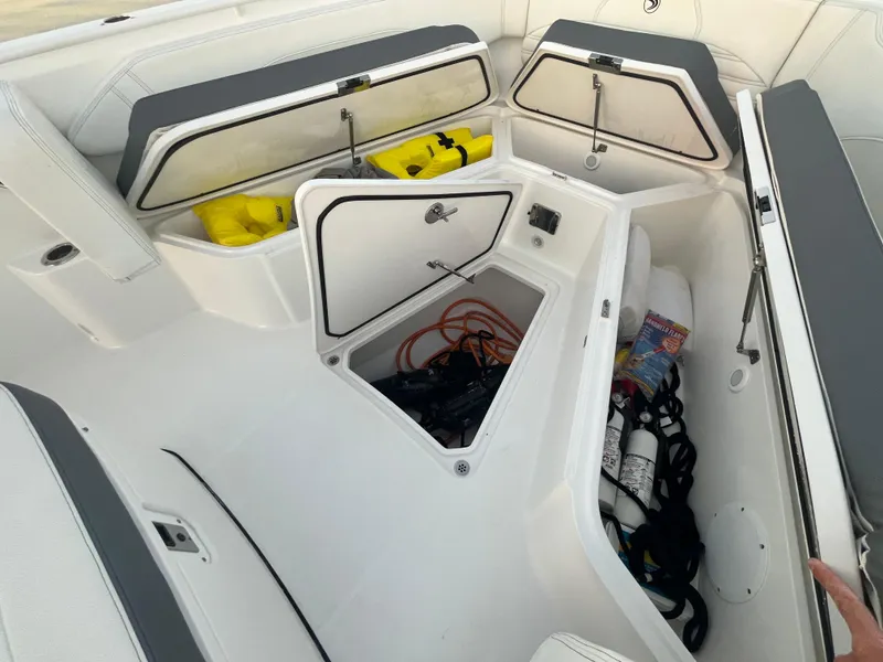 Slide: The Image of 2022 Edgewater 340CC boat storage compartments with safety equipment and supplies. - 25