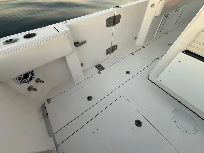 Slide: The Image of 2022 Edgewater 340CC boat deck with clean, white finish and secure fittings. - 28